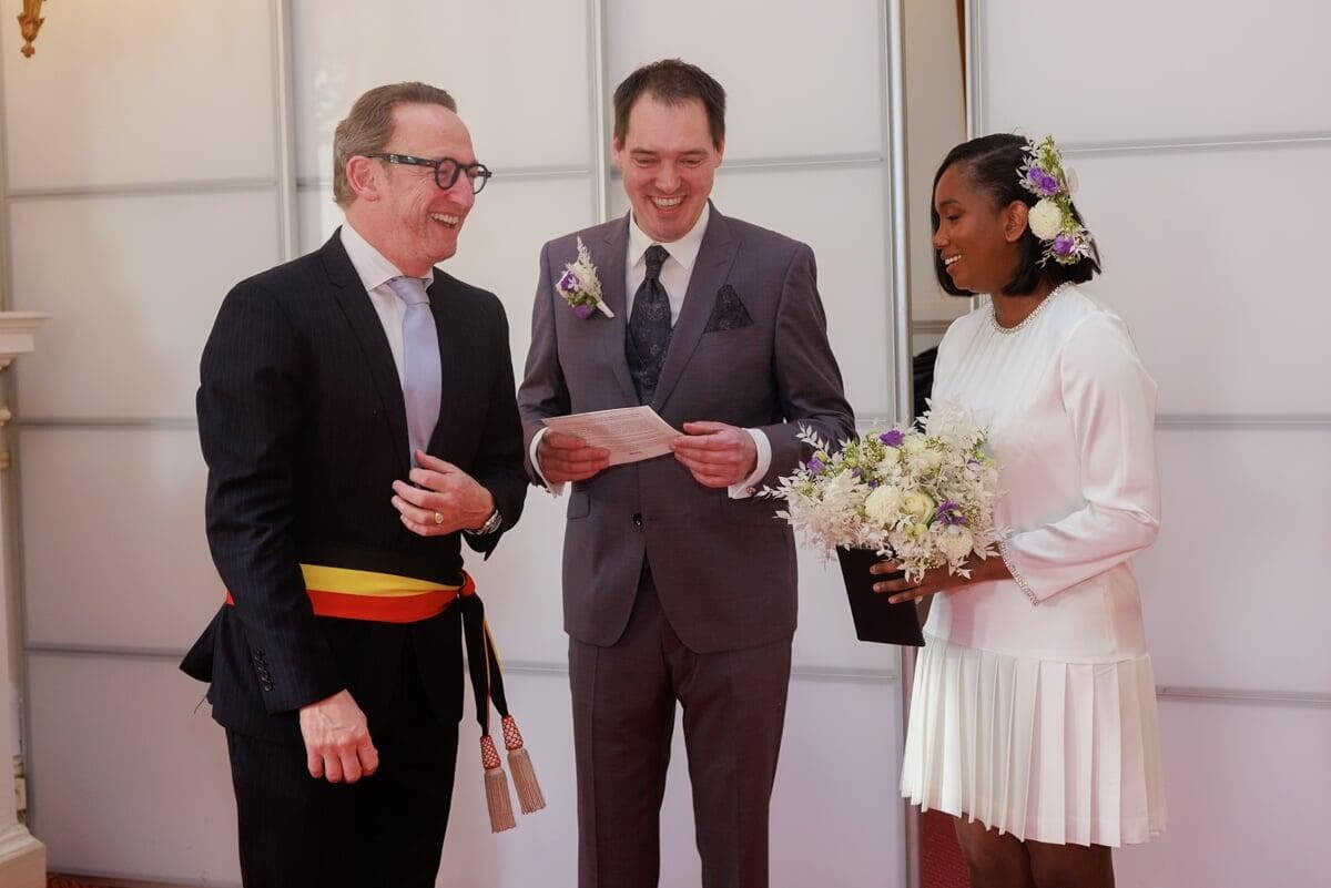 Mayour and wed couple laughing